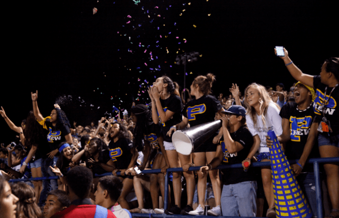 Students at Pflugerville High School cheer for their friends and classmates at a Friday night football game. (Credit: Dixie Ross)