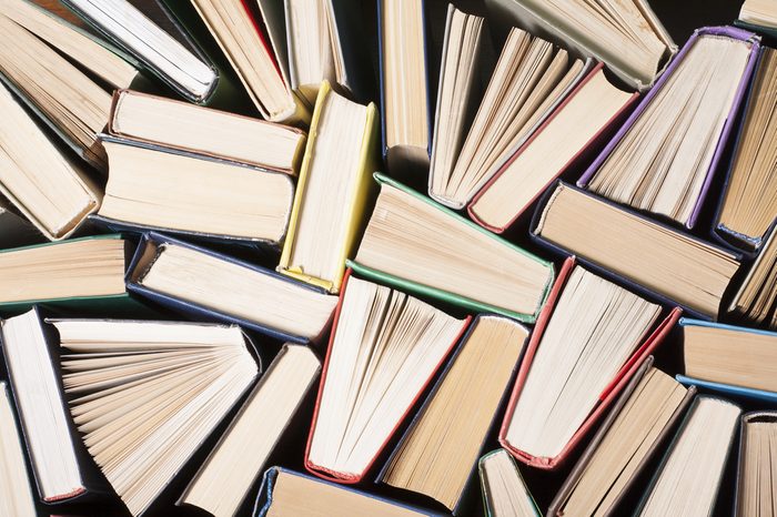 Open book, hardback books on wooden table. Education background. Back to school. Copy space for text.