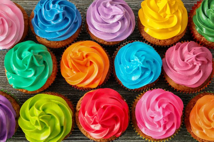 Tasty colorful cupcakes on table