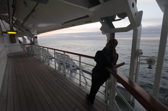 A passenger aboard the MS Balmoral Titanic memorial cruise ship watches as the ship approaches the final resting site of the Titanic in the Atlantic Ocean, . A century after the great ship went down with the loss of 1,500 lives, events around the globe are marking a tragedy that retains a titanic grip on the world's imagination - an icon of Edwardian luxury that became, in a few dark hours 100 years ago, an enduring emblem of tragedy