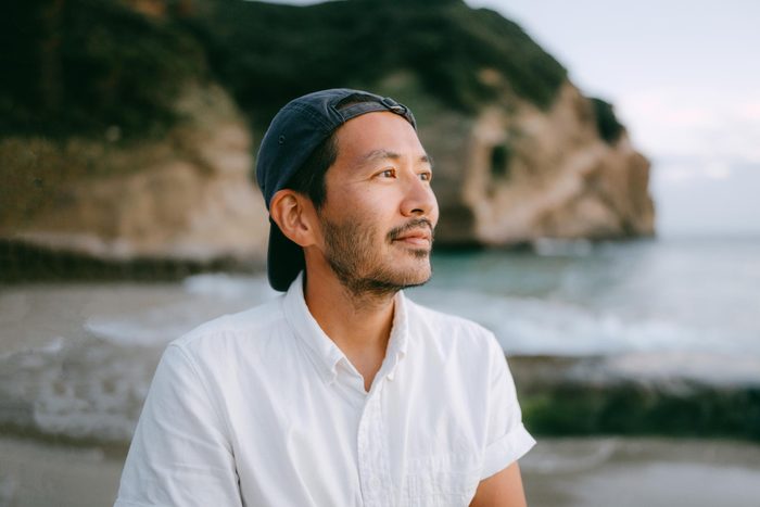 portrait of a man on a beach during sunset