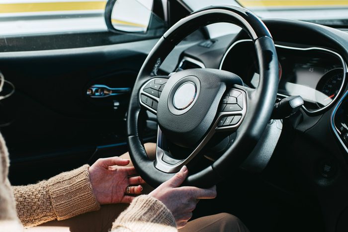 woman's hands near the Steering Wheel