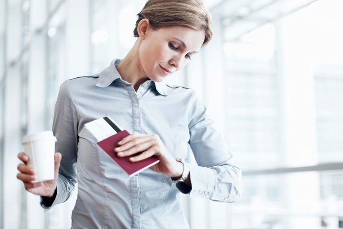 Airplane travel tip woman with coffee and boarding pass