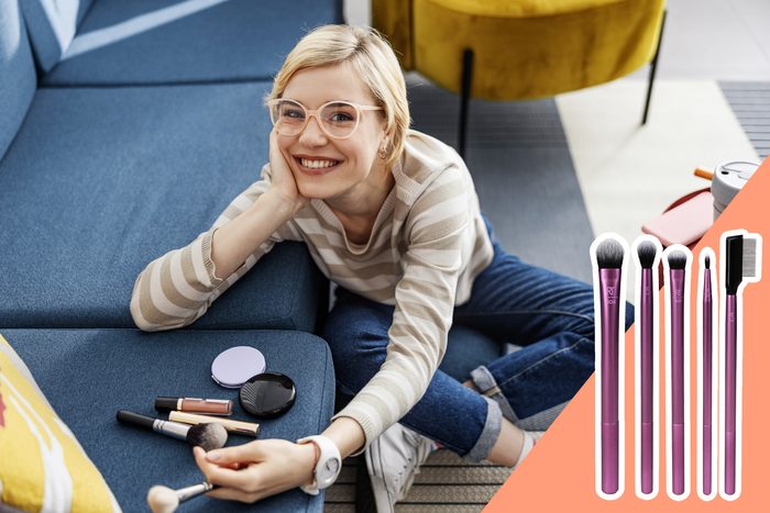 woman in glasses with make up and brushes