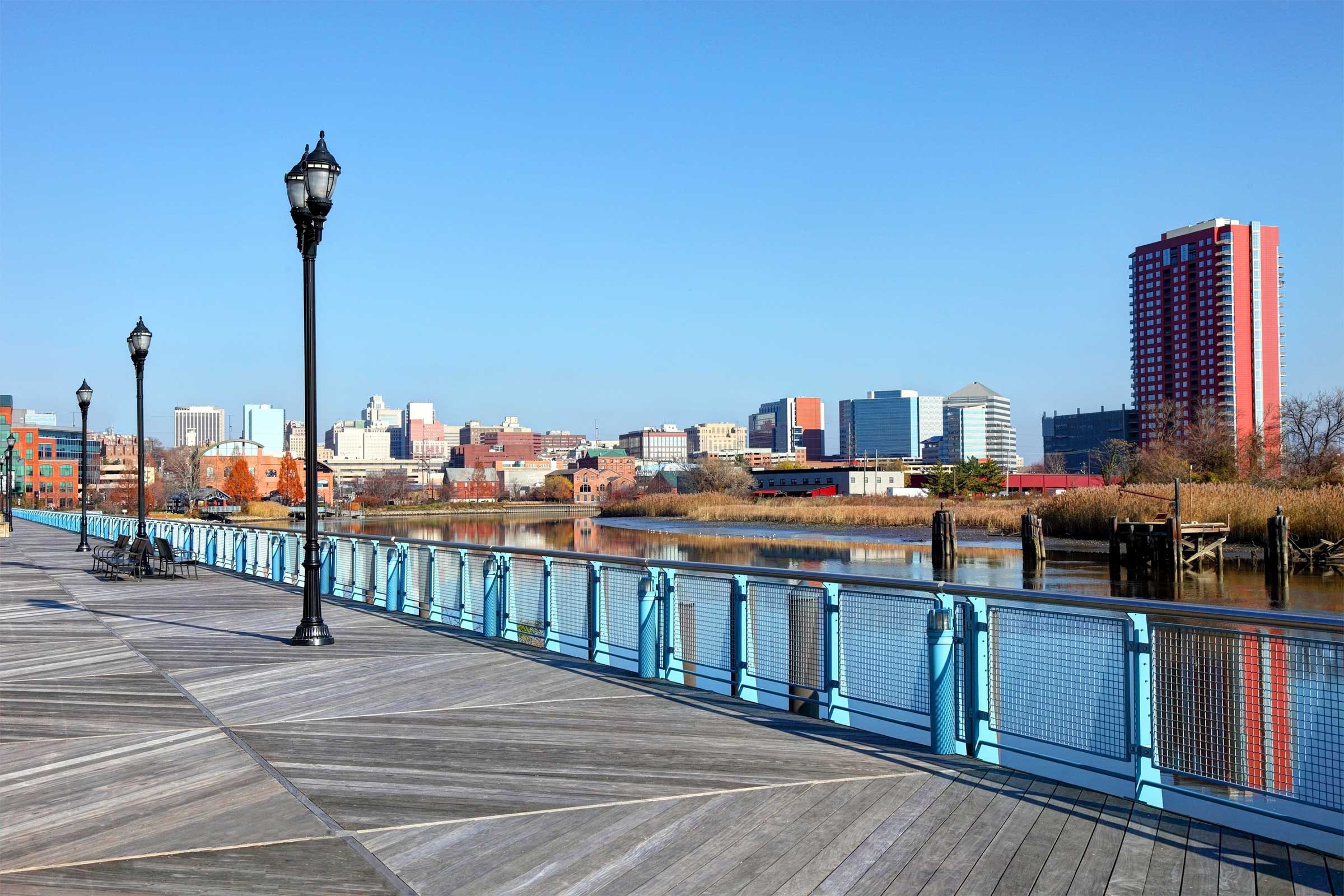 boardwalk by the brandy wine river with a city skyline in the background