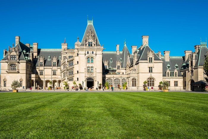 old mansion in North Carolina with a large lawn of green grass and blue sky