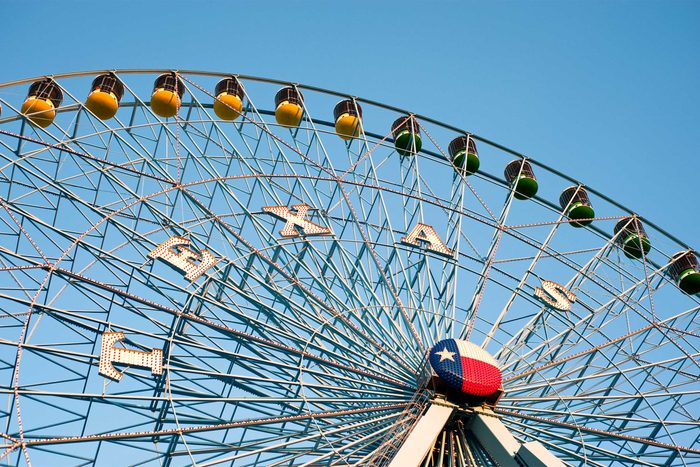 looking up at an empty Ferris wheel that says 'Texas'