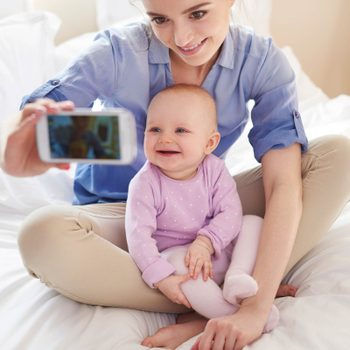 adult holding phone for baby