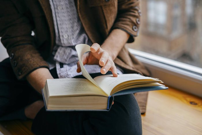 close up of man reading a book