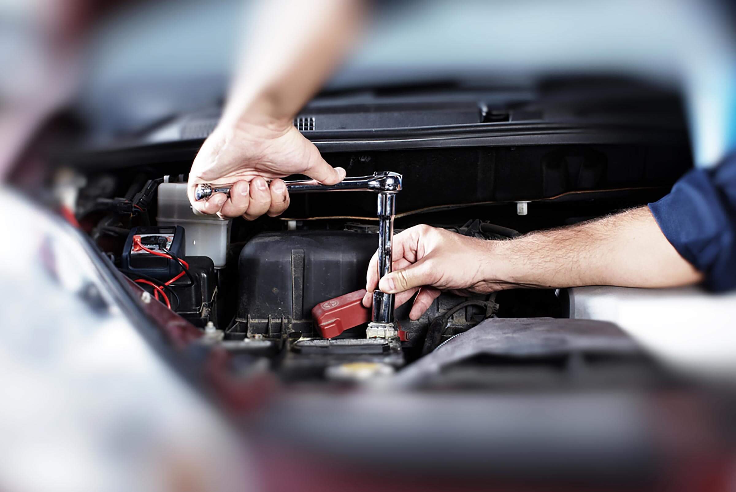 car maintenance worker working on car engine