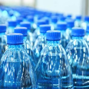 Closeup on mineral water bottles in raw and lines