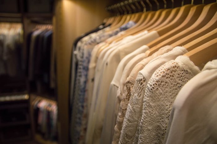 Luxurious walk in closet with lighting.