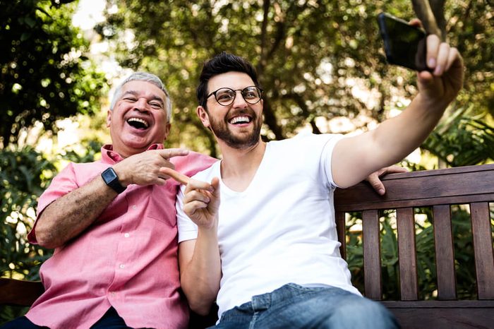 Dad and son taking selfie and having fun in the park