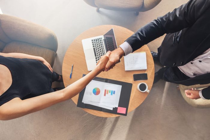 Business colleagues handshake. Businesspeople shaking hands after a successful meeting.