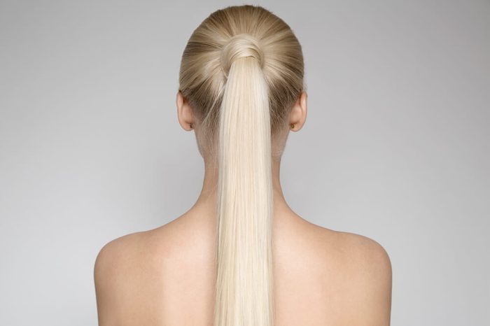 Portrait Of A Beautiful Young Blond Woman With Ponytail Hairsty?le. Back view