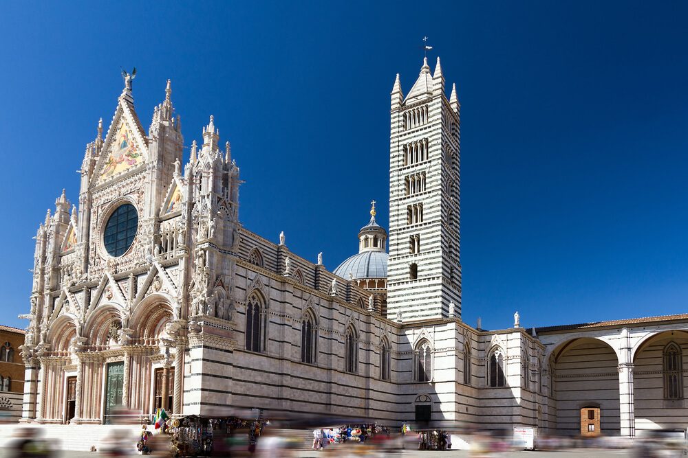 Siena cathedral against a bright blue sky in Italy