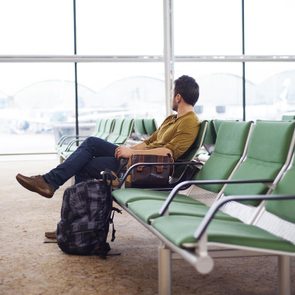 Young man at the airport waiting for his plane 