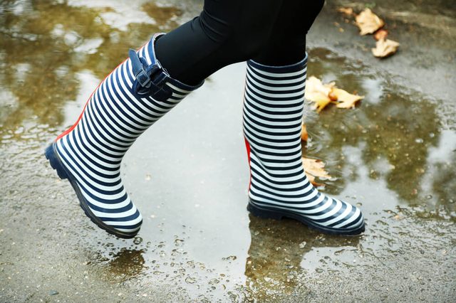 Woman in Boots on rainy autumn day.