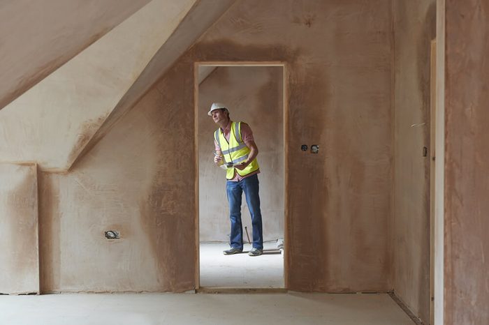 Building Inspector Looking At New Property