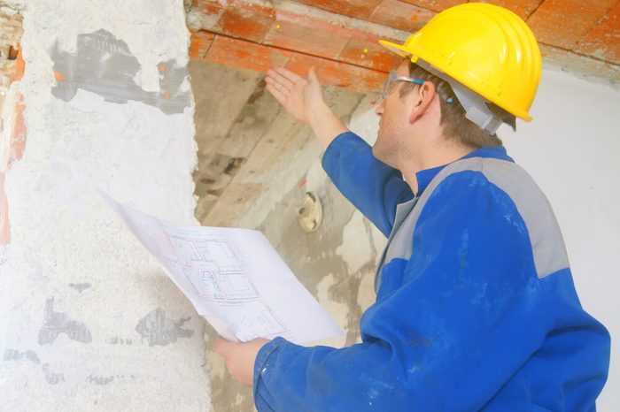 Construction worker looks at the ceiling