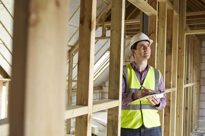 Building Inspector Looking At New Property