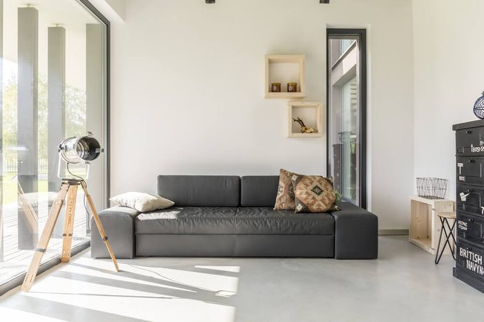 White living room with black furniture and window