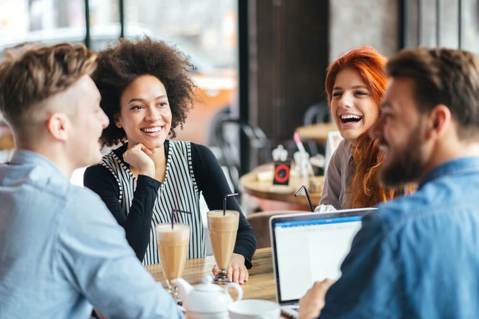 Young smiling people enjoying coffee