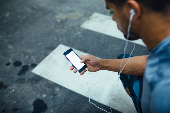 Shot from above of african american athlete man using mobile phone.