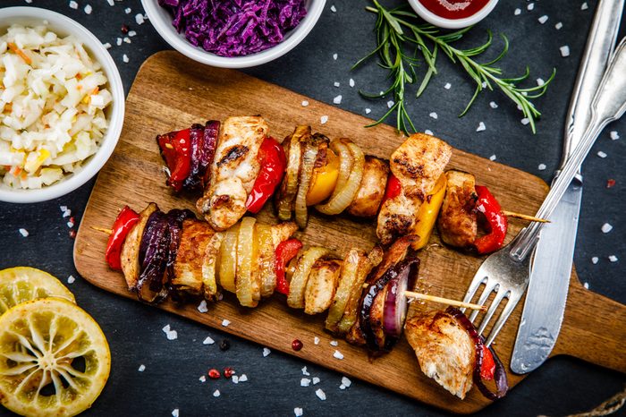 Kebabs - grilled meat and vegetables on white background