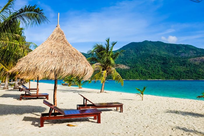 This is the vacation time show wood chairs on a beautiful tropical beach with white sand and clear turquoise ocean at exotic island