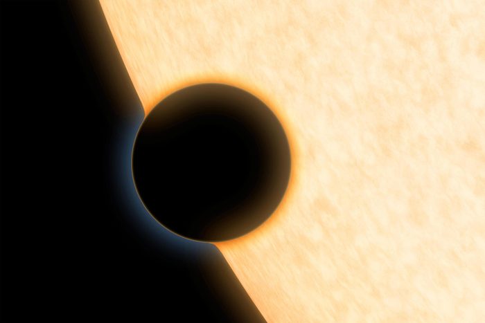 A Neptune-size planet with a clear atmosphere is shown crossing in front of its star in this artist depiction. Such crossings, or transits, are observed by telescopes like NASA Hubble and Spitzer to glean information about planets atmospheres.