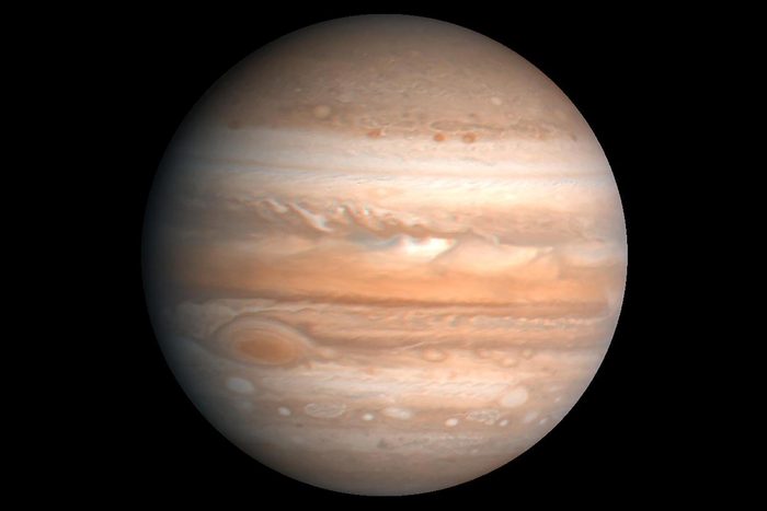 This processed color image of Jupiter was produced in 1990 by the U.S. Geological Survey from a Voyager image captured in 1979. Zones of light-colored, ascending clouds alternate with bands of dark, descending clouds.