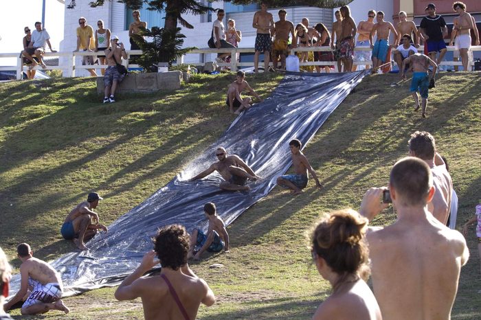 Bored surfers having fun on a Slip n Slide