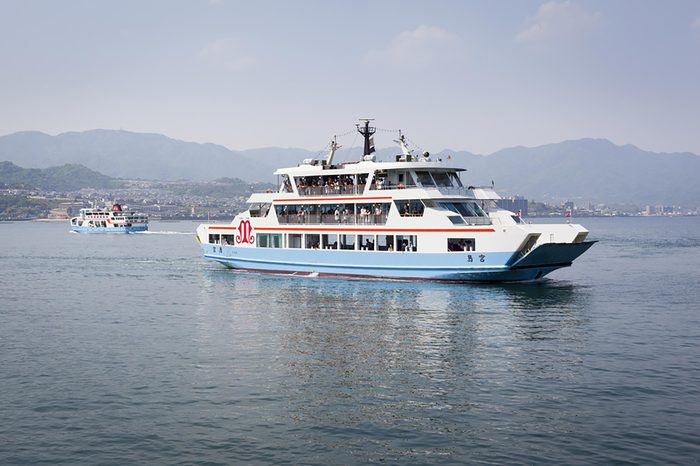 MIYAJIMA, JAPAN - MAY 5: Matsudai Kisen ferries crossing the inland sea between Miyajimaguchi and Miyajima on 5th May 2012. The Ferries carry visitors to the Itsukushima Shrine on Itsukushima island.