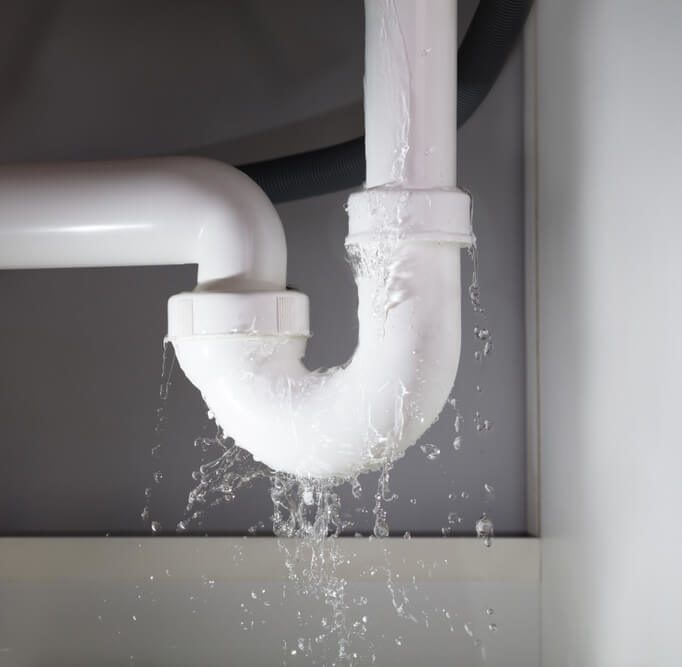 Close-up Of Water Is Leaking From The White Sink Pipe