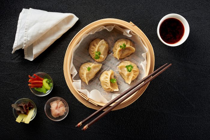 Dim sum dumplings in steamer and ingredients top view