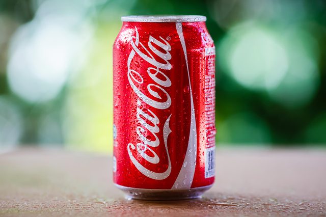 SABAH, MALAYSIA April 10, 2015 : Coca-Cola can with background blurring tree in a park. suitable for decorating supermarkets and restaurants