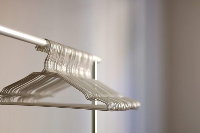 White wire hangers on an empty clothes rack. Selective focus. 