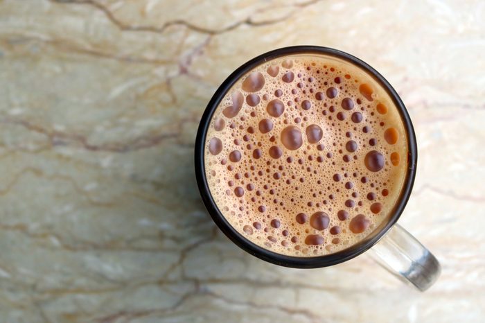 Top view of Teh tarik, the famous Malaysian tea, on the marble table.