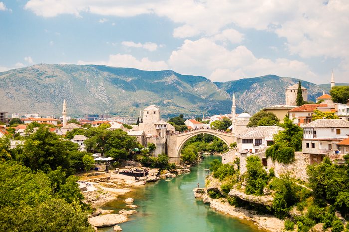 Beautiful view on Mostar city with old bridge, mosque and ancient buildings on Neretva river in Bosnia and Herzegovina