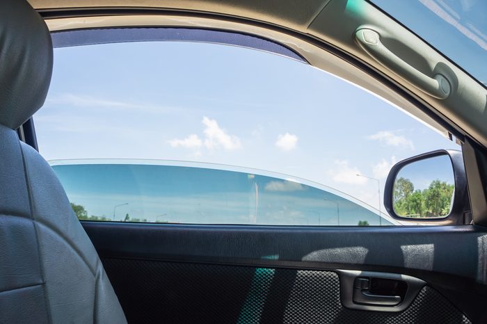 The door car open window glass with blue sky view.