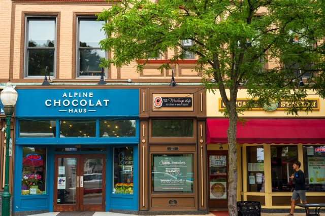 PLYMOUTH, MI - JULY 17, 2016: Culinary outlets, shops, and businesses line the tree-shaded sidewalk along South Main Street in this quaint suburb of Detroit.