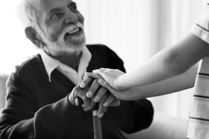 Grandson holding grandpa's hands