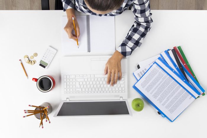 Overhead View Of Businesswoman Working At Computer In Office