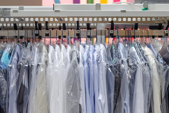 Clean clothes on hangers in the laundry room