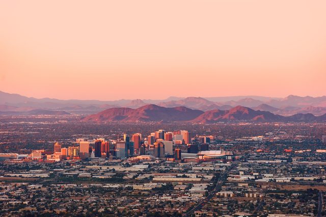 Phoenix Arizona with its downtown lit by the last rays of sun at the dusk.