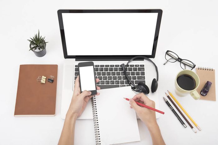 Modern Office desk with computer, notebook, headset, paper book and coffee cup.Top View table from above with copy space for input the text.