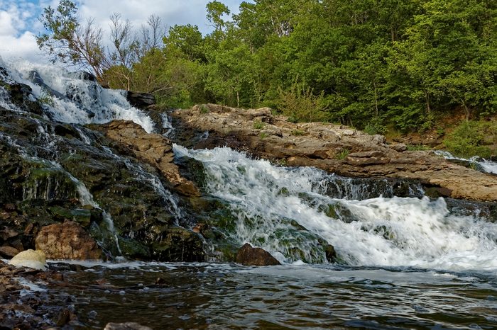 Water rushes over the Lake MacBride Waterfall