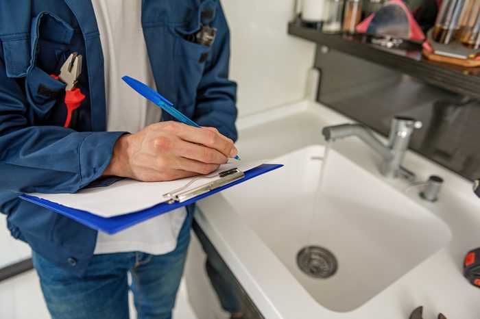 Male person keeping blue clipboard