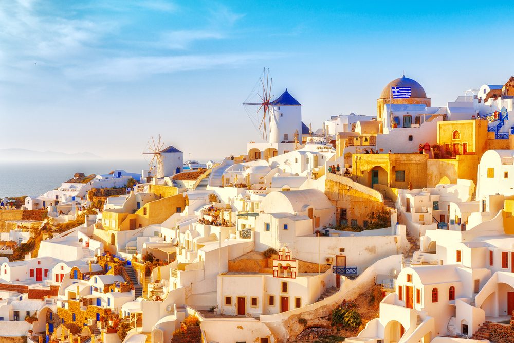 Skyline of Oia, traditional white architecture with windmills, greek village of Santorini, Greece. Santorini is island in Aegean sea, famous summer resort.